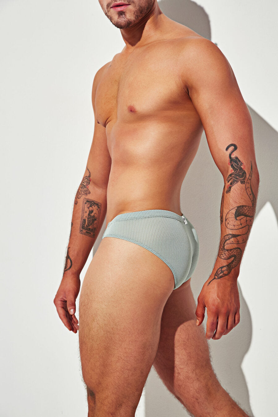 Side view of the mint green mesh thong — showcases a snug, seamless fit with contour-enhancing support and breathable fabric ideal for all-day wear.