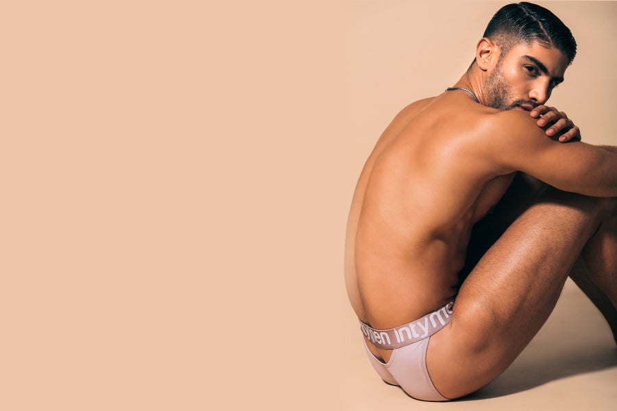 5 reasons to celebrate Christmas in Intymen's men's brief underwear - Man sitting and hugging his knees while wearing light-colored underwear.
